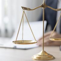 Lawyers or judges sign documents in accordance with legal and fa Lawyers or judges sign documents in accordance with legal and fair terms of agreement, Legal Ethics and Integrity, scales of justice, law hammer, Litigation and legal services.